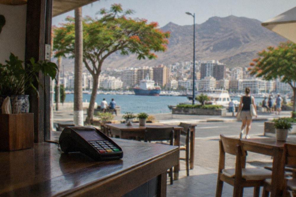 A card terminal on the counter of a small seaside restaurant