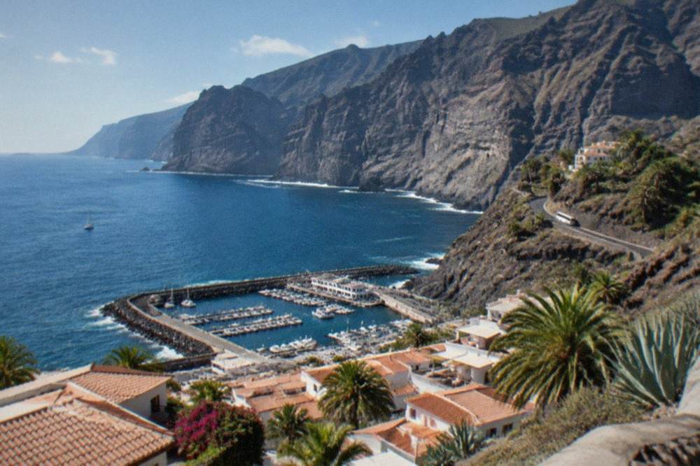 A view over rooftops at Los Gigantes towards the harbour, with the cliffs beyond