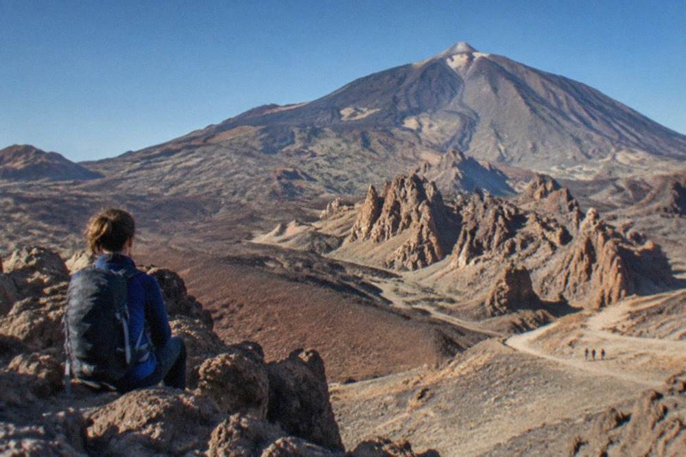 Mount Teide rising above a volcanic landscape under a clear blue sky