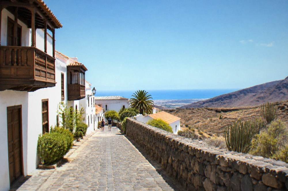 A quiet cobbled street with traditional wooden balconies in Adeje old town