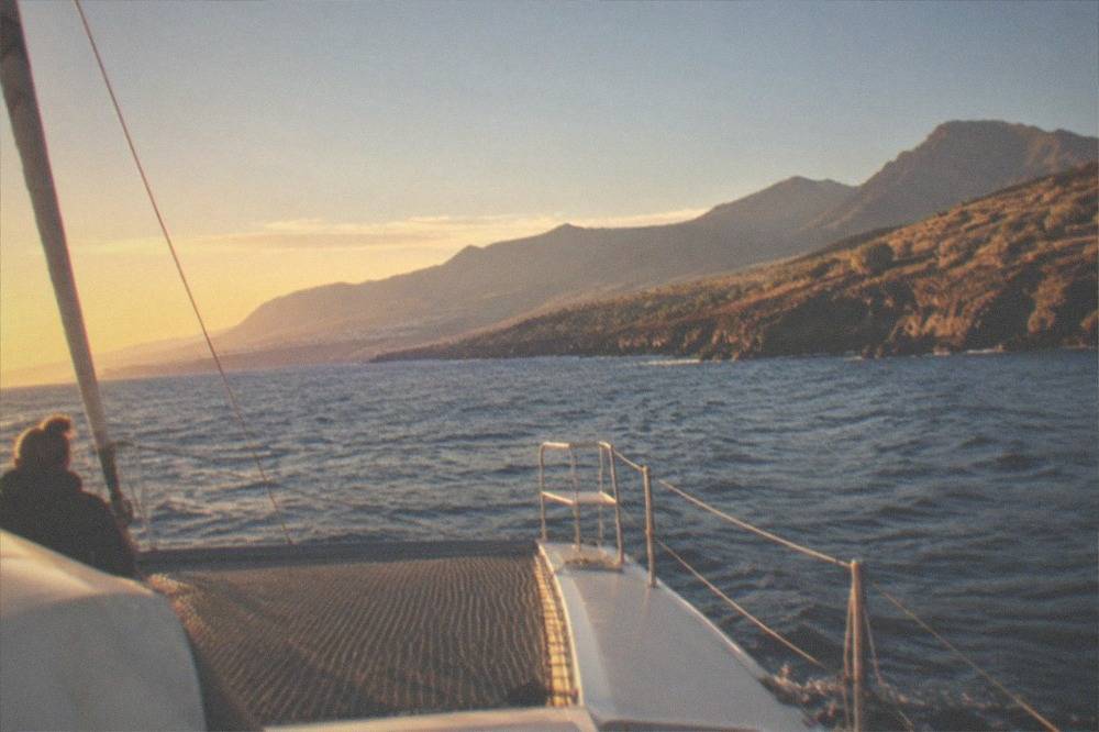 A catamaran under way on open water near the Tenerife coast