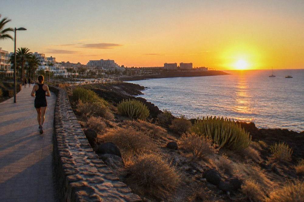 Sunset over the sea from the Costa Adeje coast with hotels silhouetted