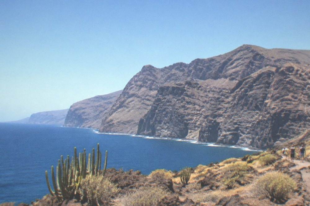 Tall dark cliffs rising straight out of the sea on the south-west coast of Tenerife
