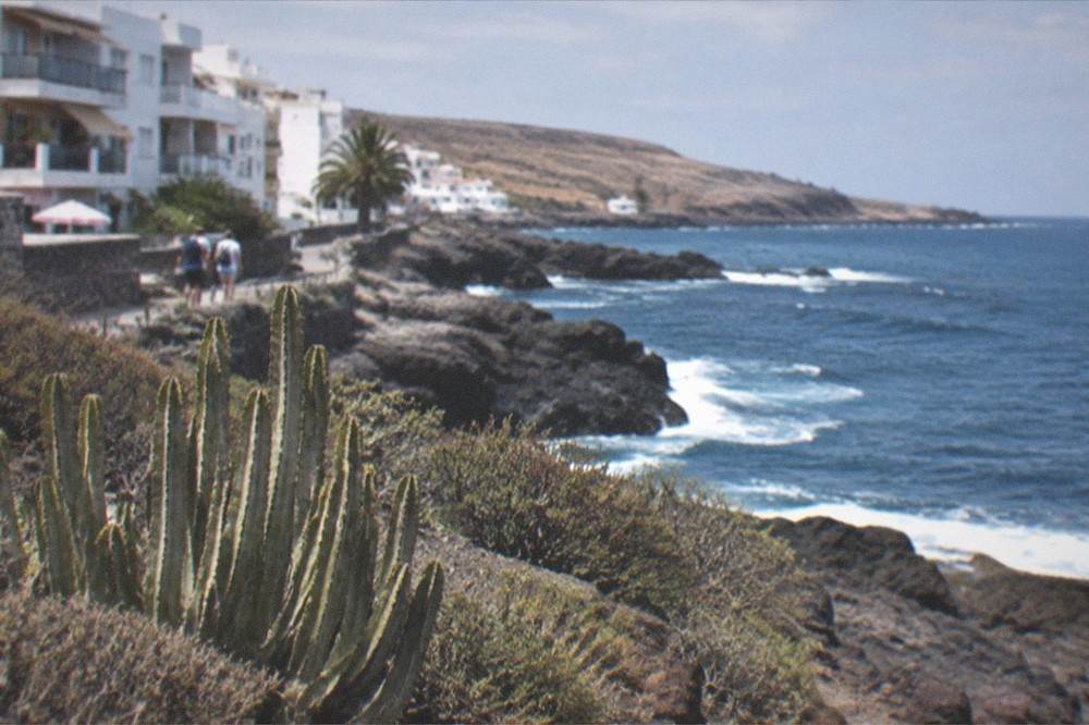 Low white holiday apartments with balconies facing the sea