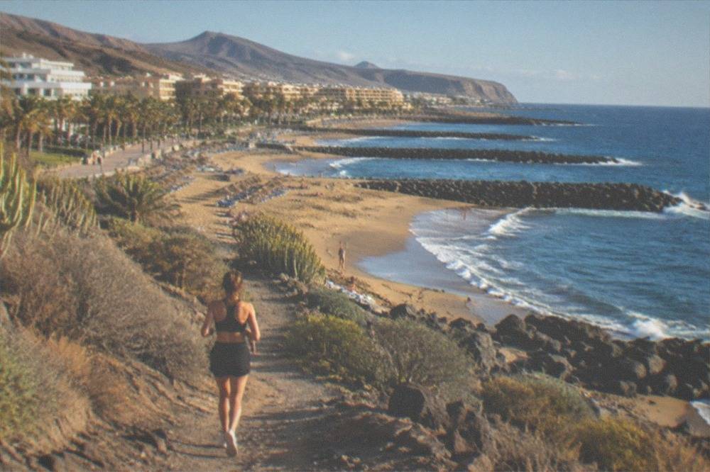 Las Vistas beach with breakwaters and sunbeds along the shore