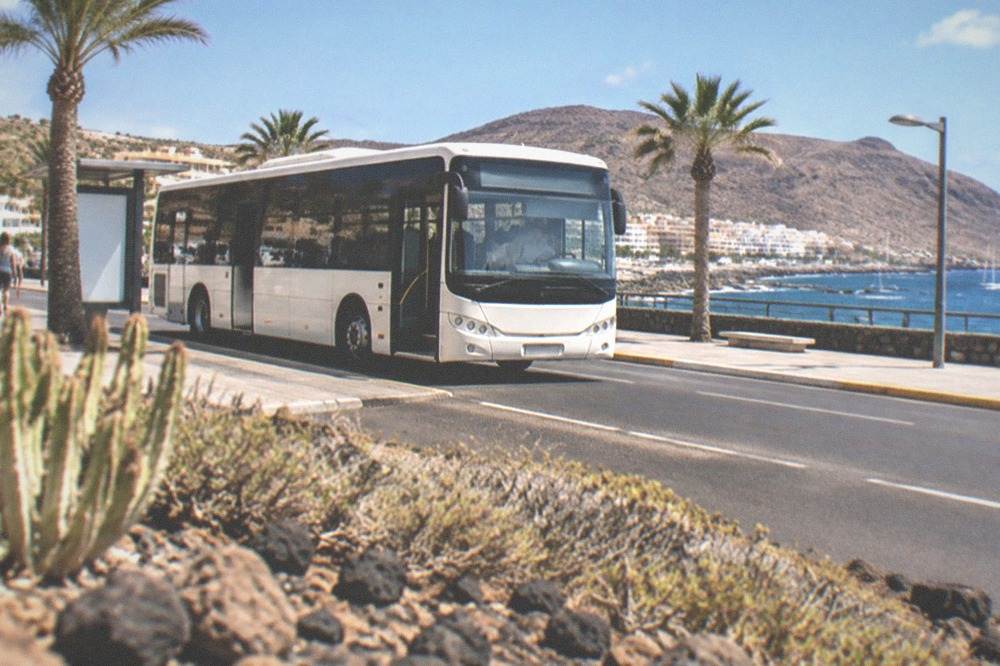 An island bus at a stop on the seafront road in Los Cristianos