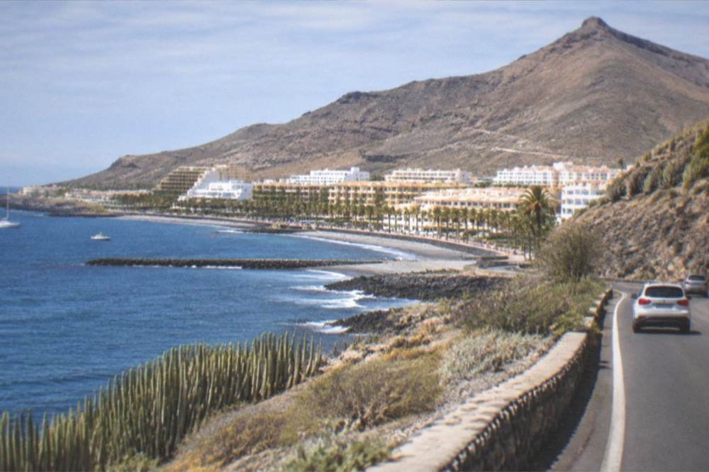 A view along the south coast road with the hills above Los Cristianos