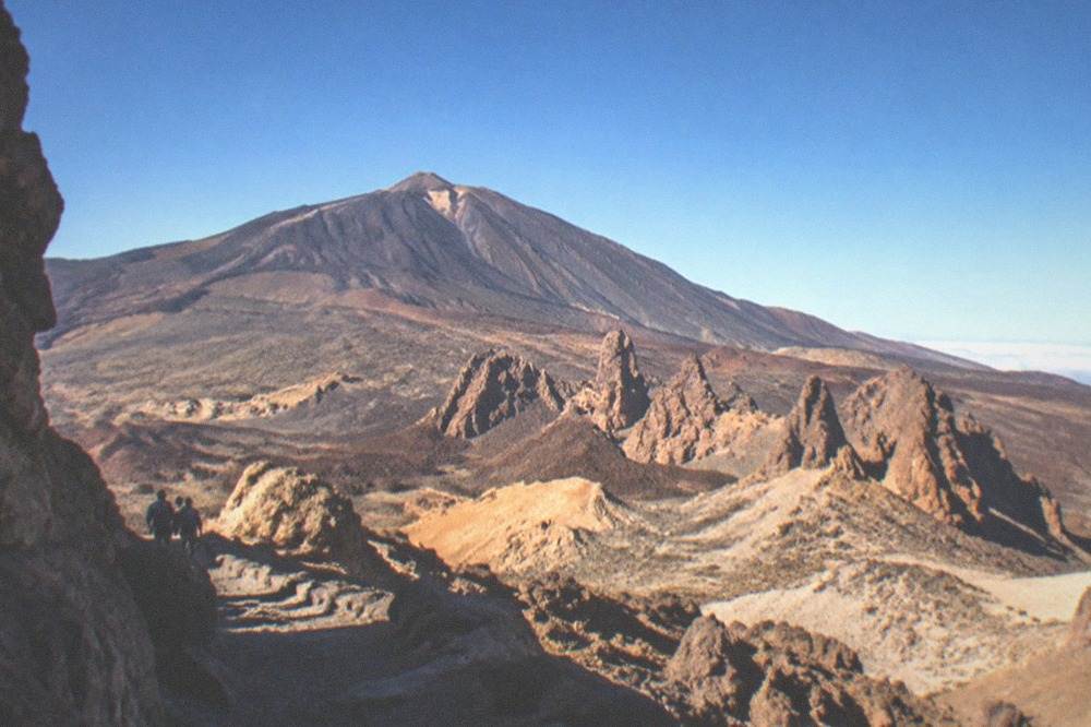Volcanic cone and rock formations under a clear sky in Teide National Park