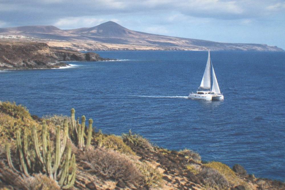 A catamaran on open water off the south Tenerife coast