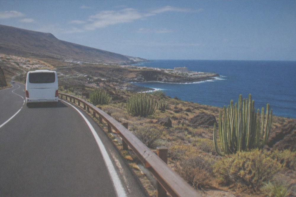 An island bus on a coastal road in southern Tenerife