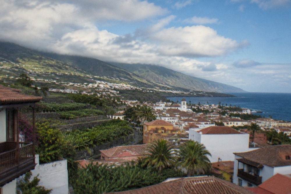 A view over the rooftops of Puerto de la Cruz toward the green slopes of the Orotava Valley