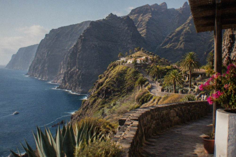 A view along the west Tenerife coastline with tall dark cliffs meeting the sea