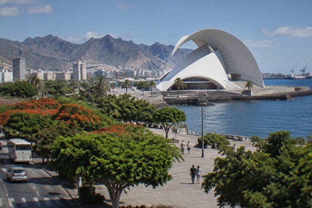 White concert hall building with a curved roof beside the sea in Santa Cruz de Tenerife