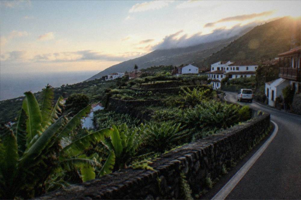 A coastal road winding along green cliffs above the Atlantic in northern Tenerife