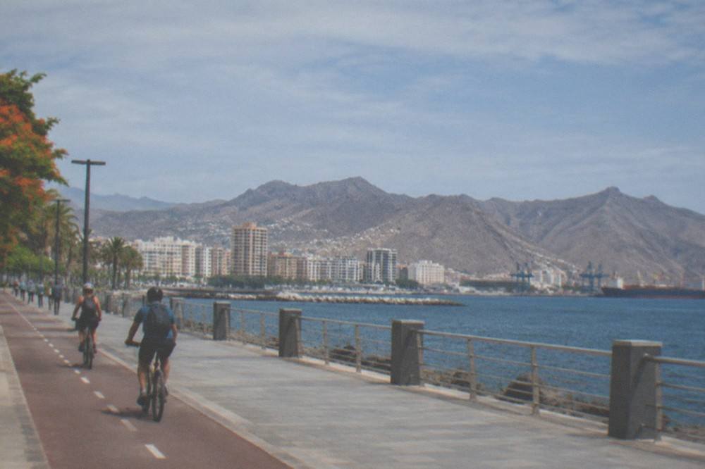 Cyclists on a seafront promenade in Santa Cruz de Tenerife