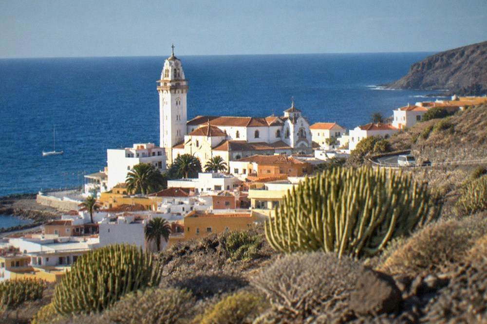 The basilica's tower rising above the rooftops of Candelaria town