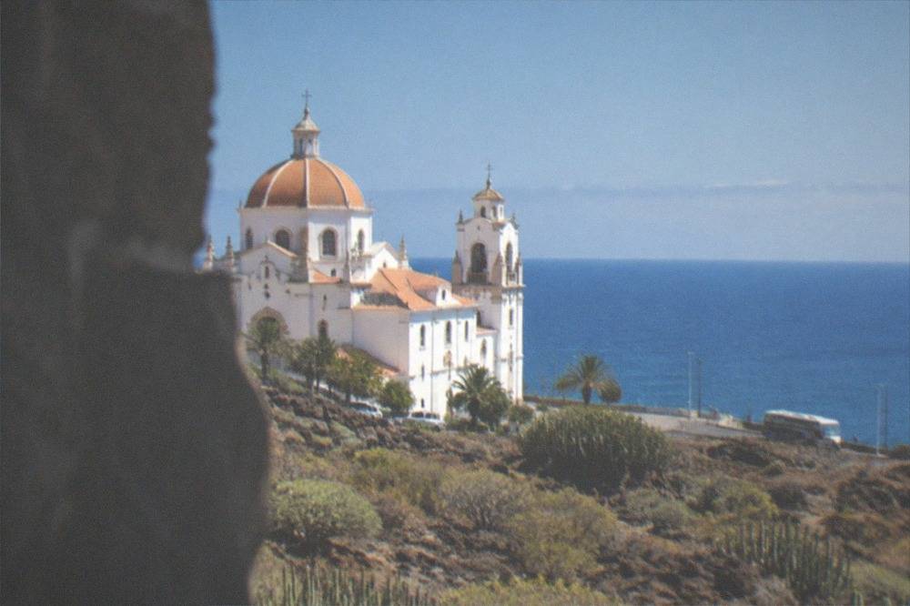 The cupola and white walls of the basilica against a clear sky