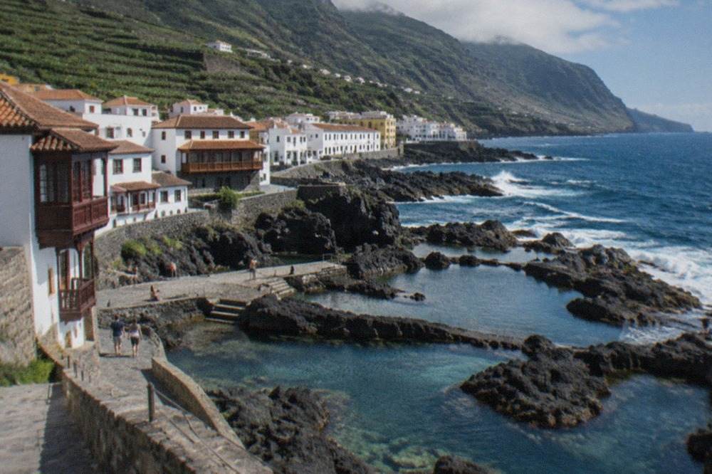 Volcanic rock pools filled with clear sea water along the waterfront at Garachico in Tenerife