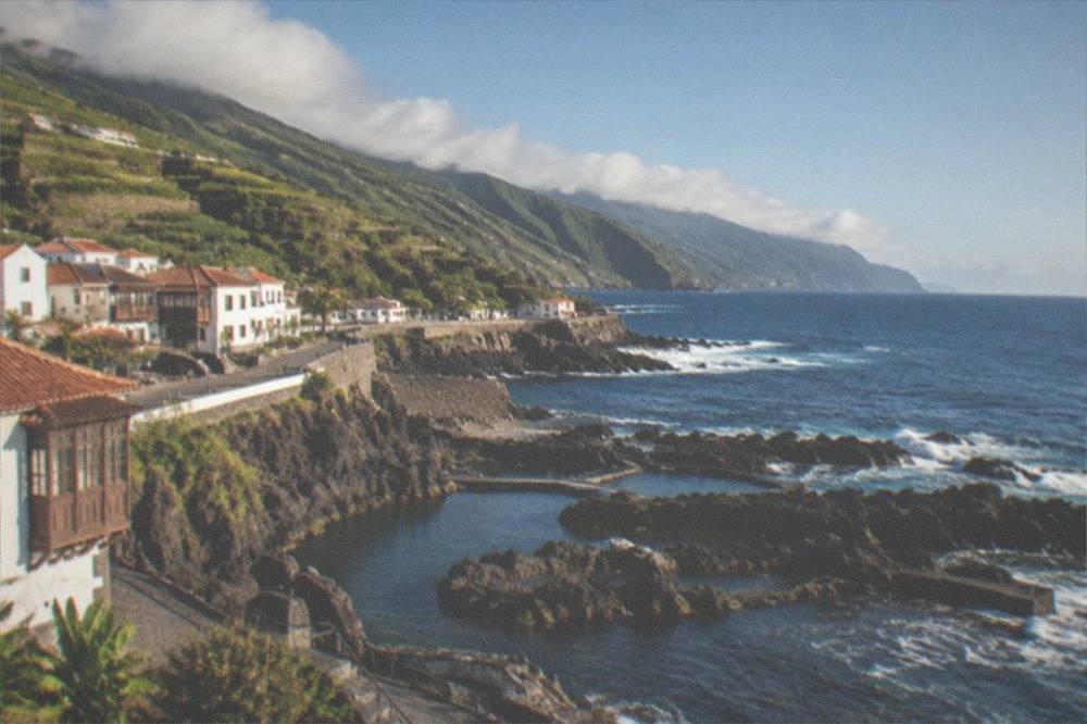 The seafront of Garachico seen from above with rock pools and the open Atlantic beyond