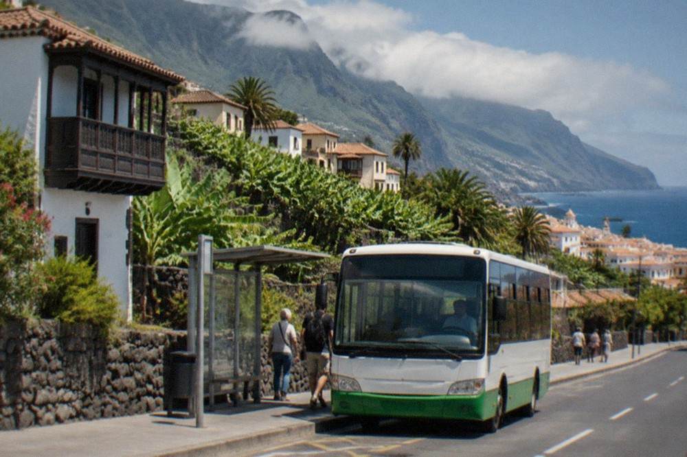 An island bus at a stop on a street in Puerto de la Cruz