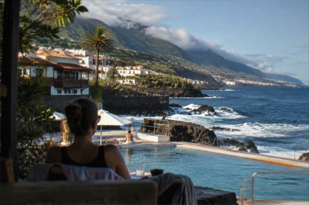 A sunny terrace beside a lido pool with the Atlantic horizon beyond