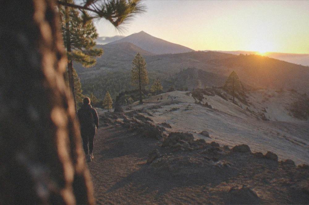 Sunrise light on pale volcanic ridges with long shadows across the ash ground