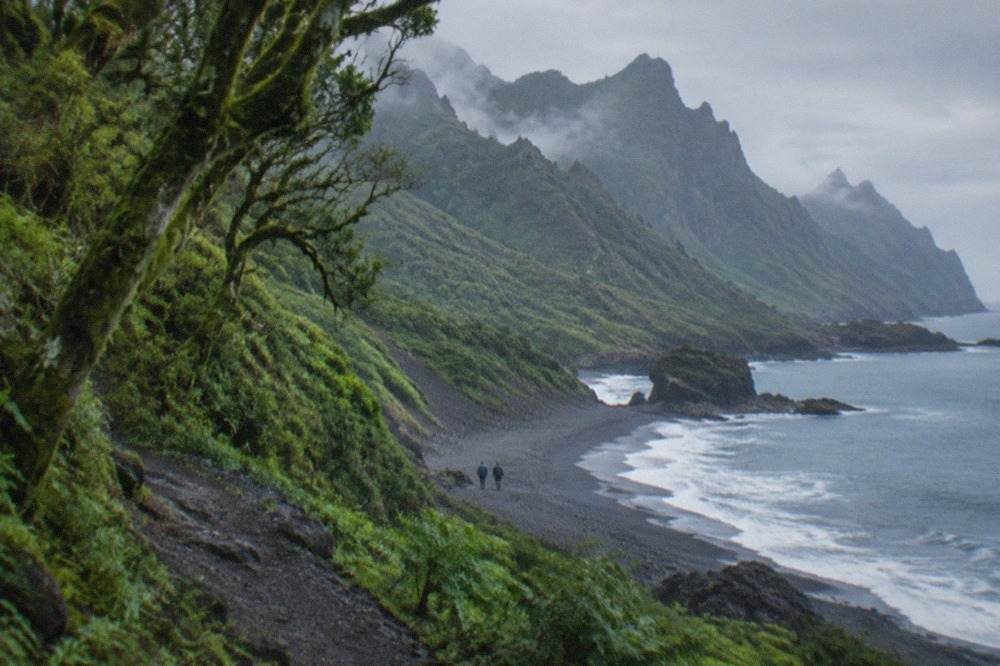 A wild Atlantic beach beneath dark green mountains on the Anaga coast of Tenerife