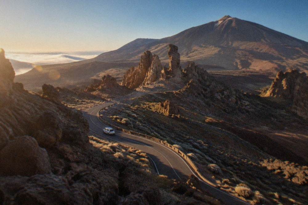 A winding road climbing through volcanic landscape toward the Roques de Garcia in Teide National Park