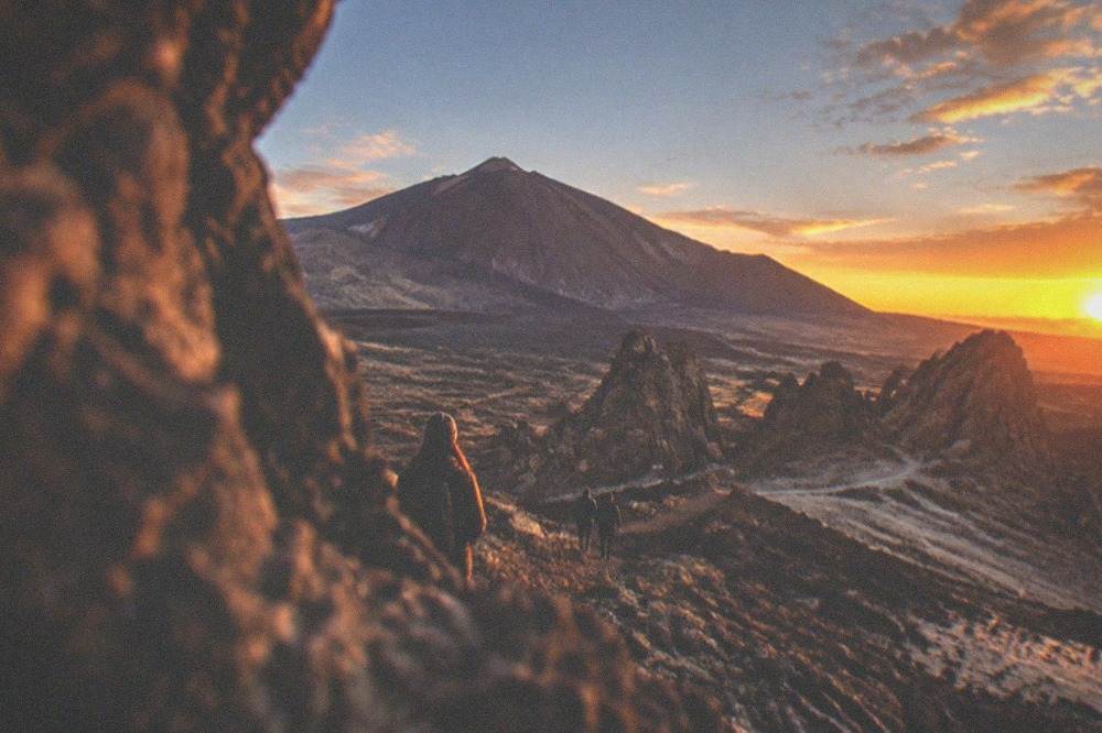 The sky turning orange over volcanic rocks at sunset in Teide National Park