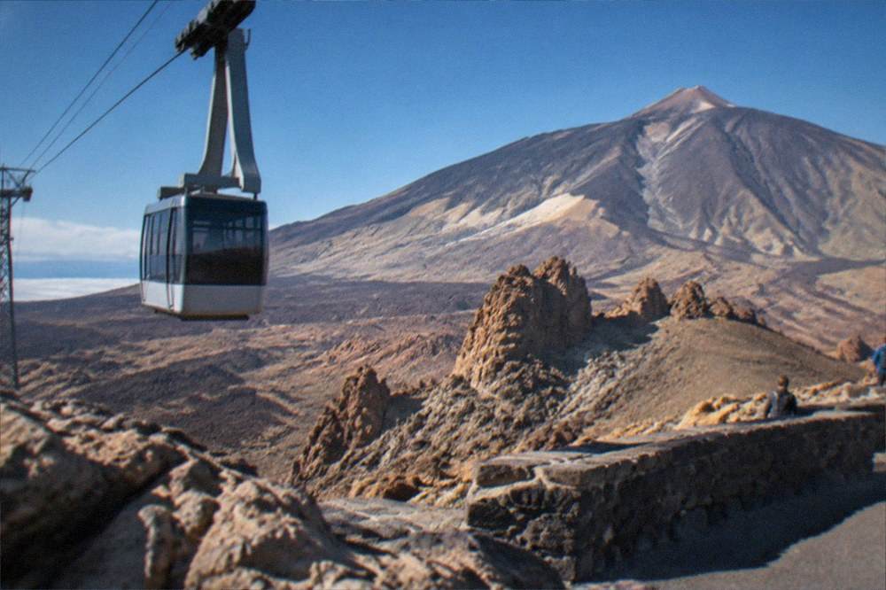 A viewpoint lay-by beside a road with volcanic rock formations in the distance