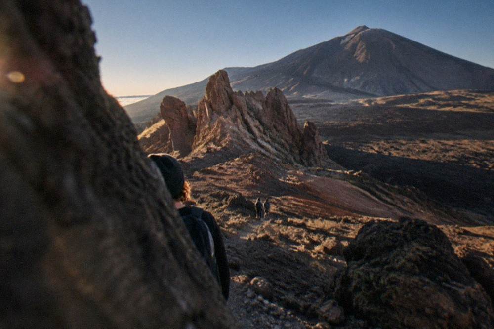 Red and ochre volcanic rock formations in Teide National Park with Teide in the background