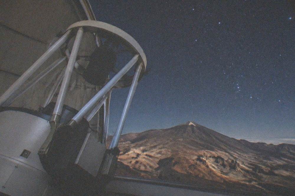 A close view of a solar telescope structure inside an observatory dome