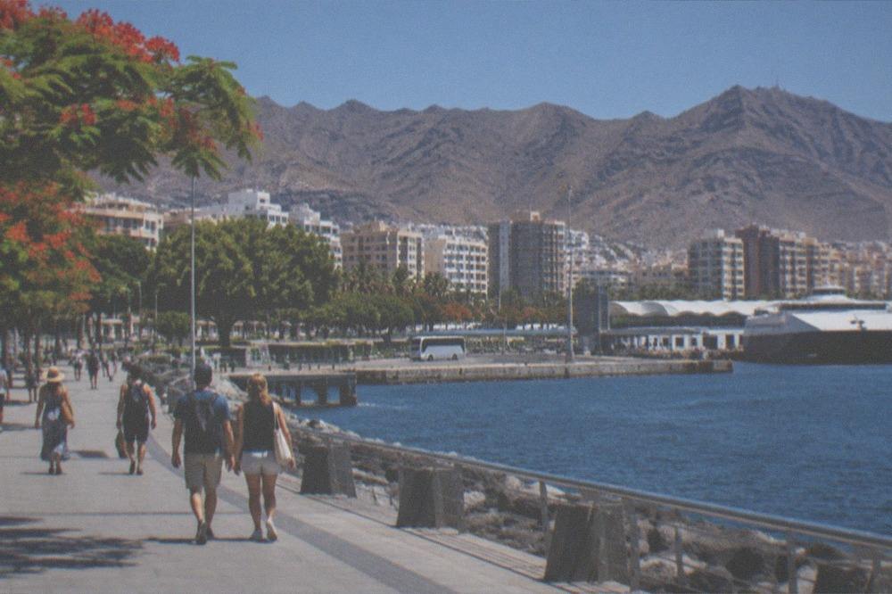 Travellers walking along the seafront at Santa Cruz de Tenerife near the ferry terminal