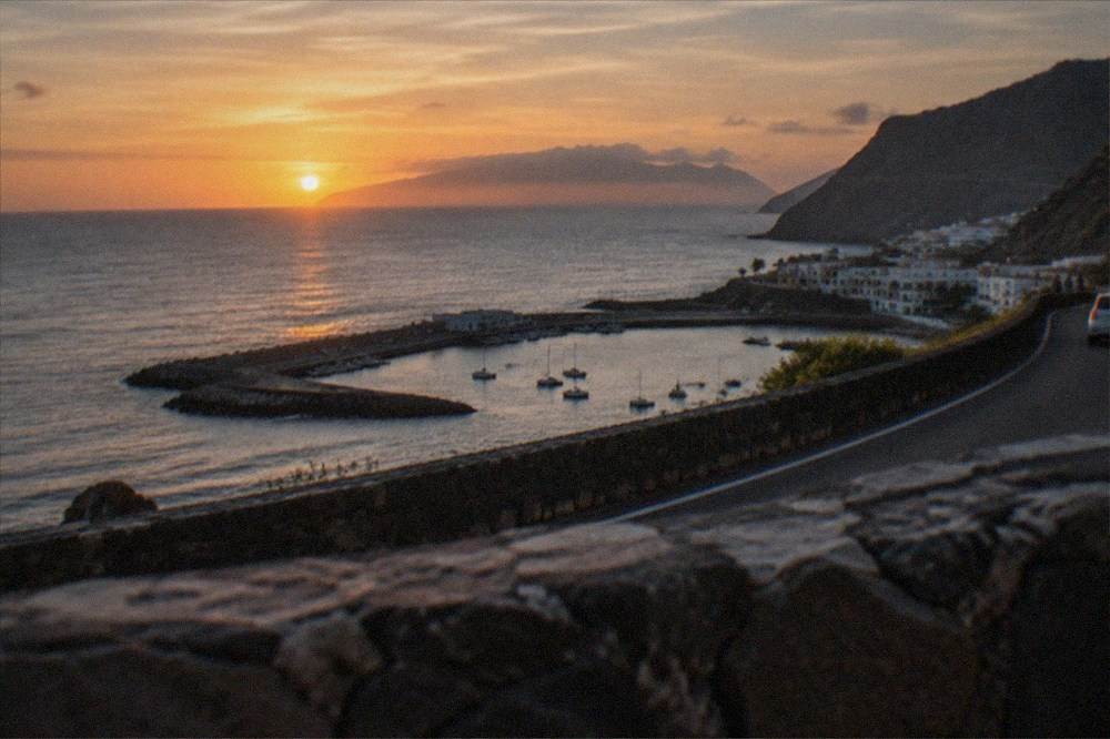 Sunset over the sea between Tenerife and Gran Canaria seen from a coastal road