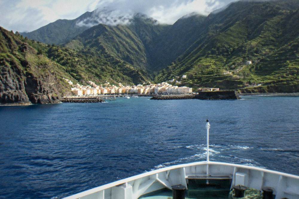 Bow of a ferry cutting through open water between two Canary Islands