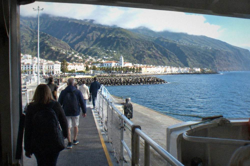 Passengers walking along a ferry gangway at a southern Tenerife port