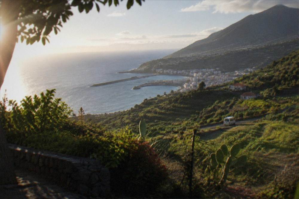 A viewpoint over terraced green hills descending towards the sea on a western Canary island