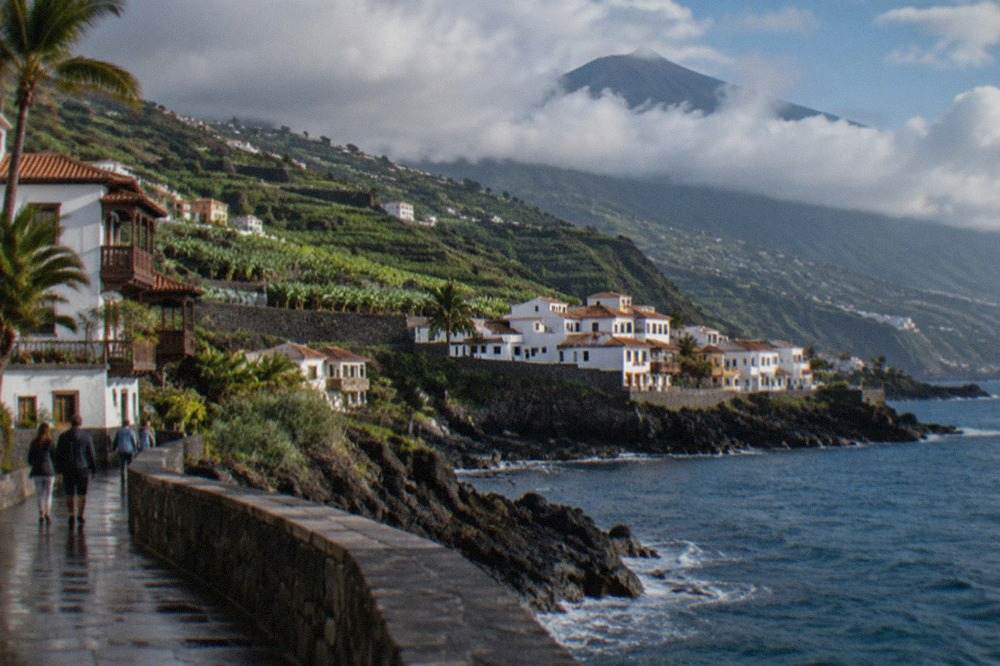Green hillsides and a volcanic cone above the north coast road of Tenerife