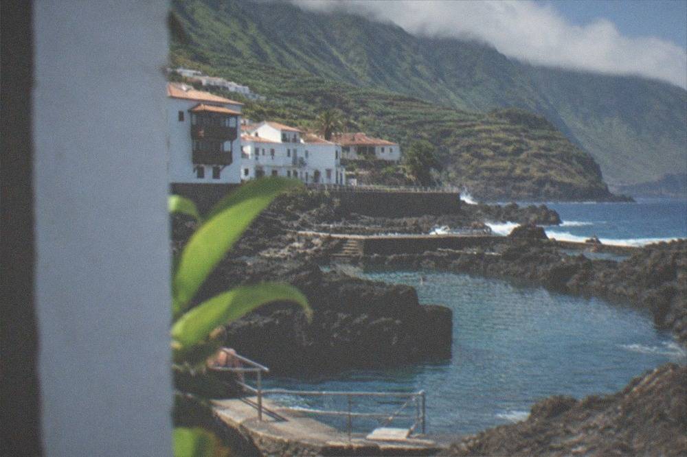Natural swimming pools set in dark lava rock along the seafront at Garachico