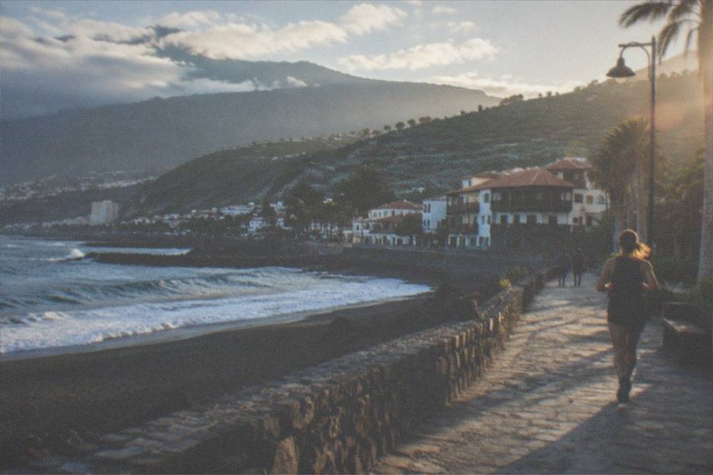 A historic seafront promenade with black sand beach in Puerto de la Cruz