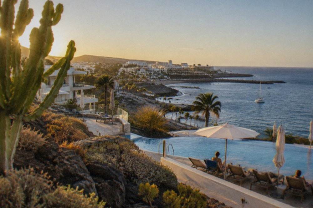 Hotel pools and sunbeds overlooking the coastline of Costa Adeje in south Tenerife
