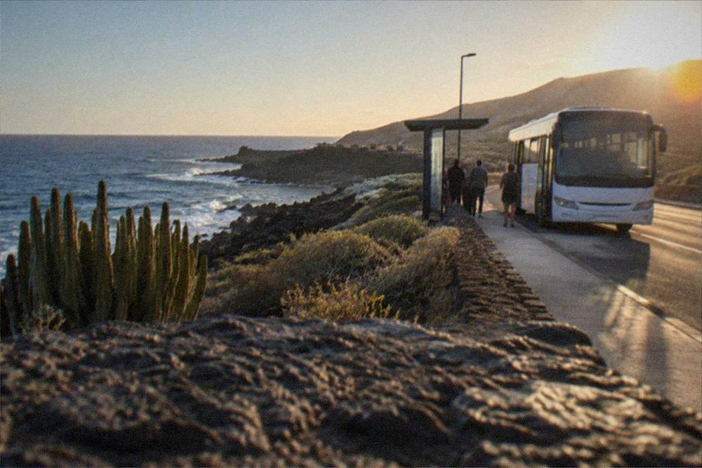 An island bus at a stop on a Tenerife road in the evening