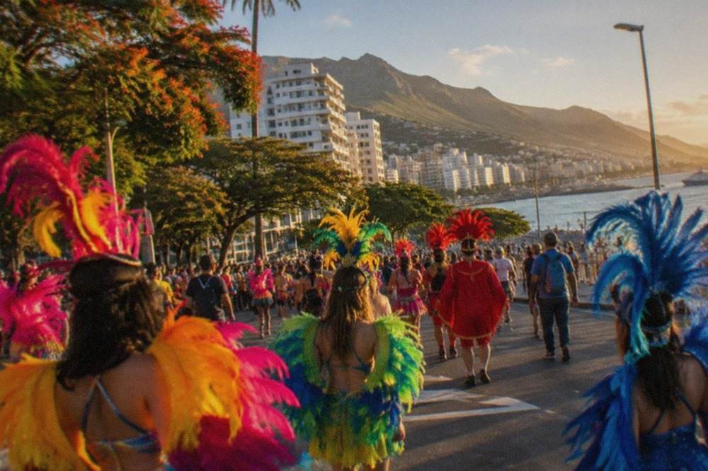 Crowds in colourful costumes at a street carnival in Santa Cruz de Tenerife