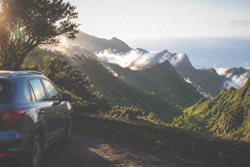 A hire car parked at a viewpoint above green Anaga mountains