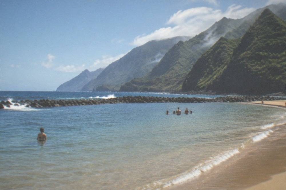 Calm shallow water over golden sand at a breakwater-protected Tenerife beach