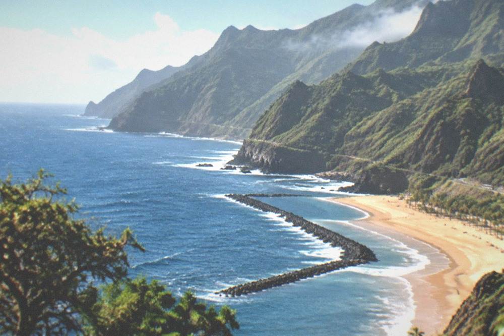 Dark volcanic sand beach beneath cliffs on the north coast of Tenerife
