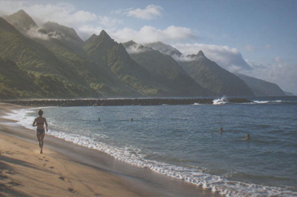 People swimming in clear water at a breakwater-protected beach in Tenerife
