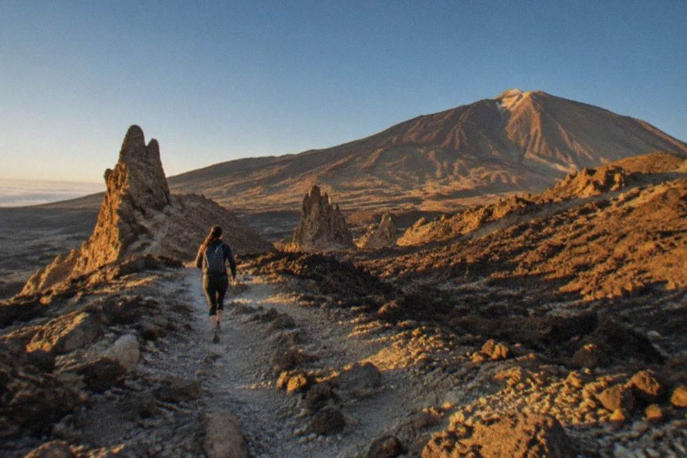 Mount Teide volcano rising above the lava fields of Teide National Park under a clear sky