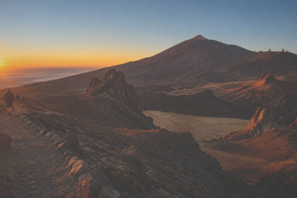 Sunset light over Teide's volcanic slopes with the observatory ridge in the distance