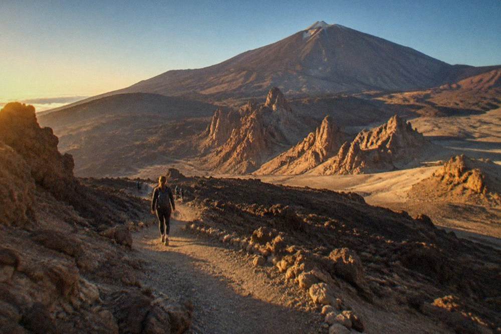 Rugged volcanic rock formations and dark lava slopes on the flanks of Mount Teide